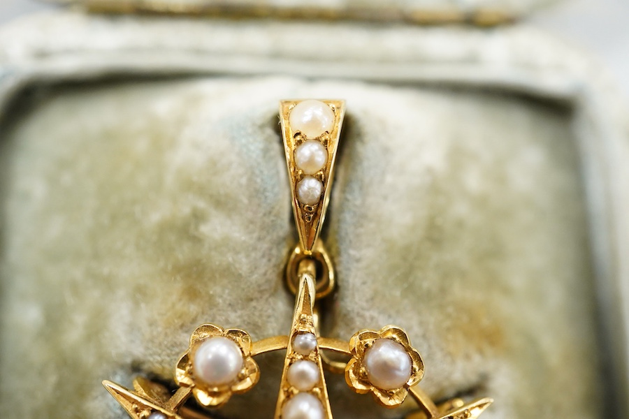 A Victorian yellow metal (stamped 18), diamond and graduated split pearl set star pendant brooch, makers mark SS, 39mm including the bale, gross weight 5.2 grams, with fitted box.